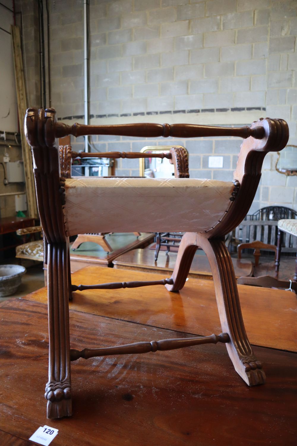 An early 20th century Anglo Burmese teak X frame stool, width 74cm